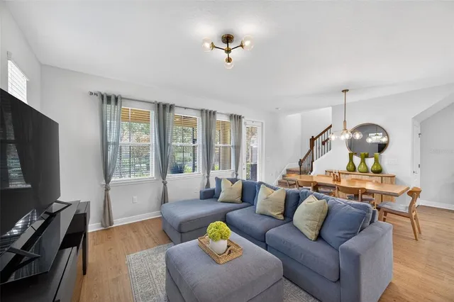 a living room with furniture and wooden floor