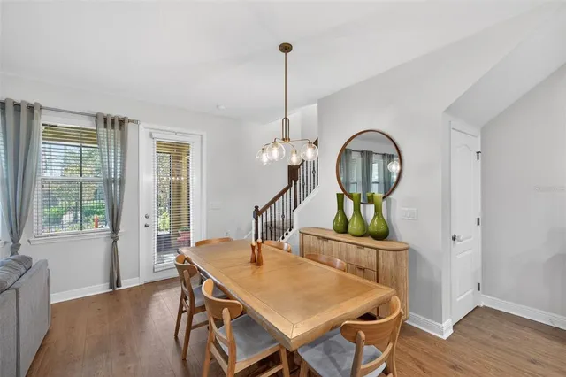 a dining room with furniture and a flat screen tv