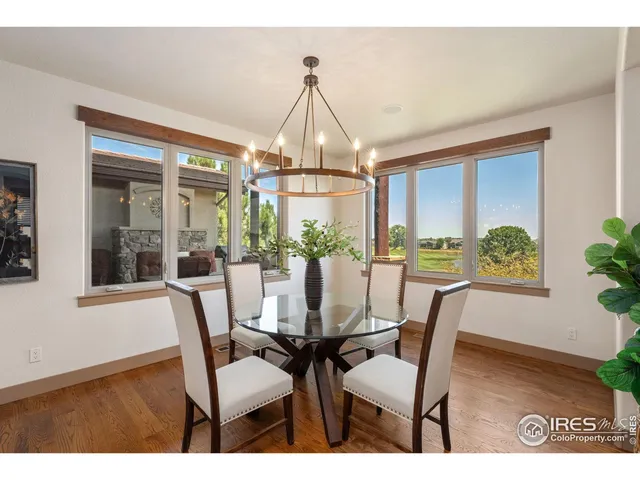 a living room with stainless steel appliances furniture a rug and a kitchen view