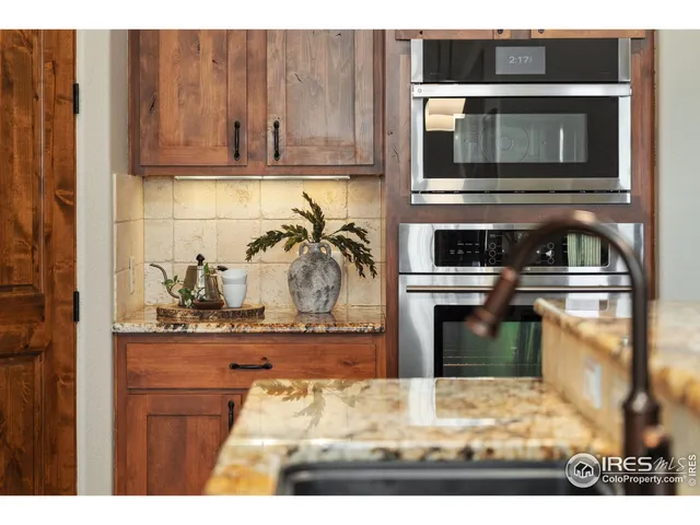 a kitchen with center island and stainless steel appliances