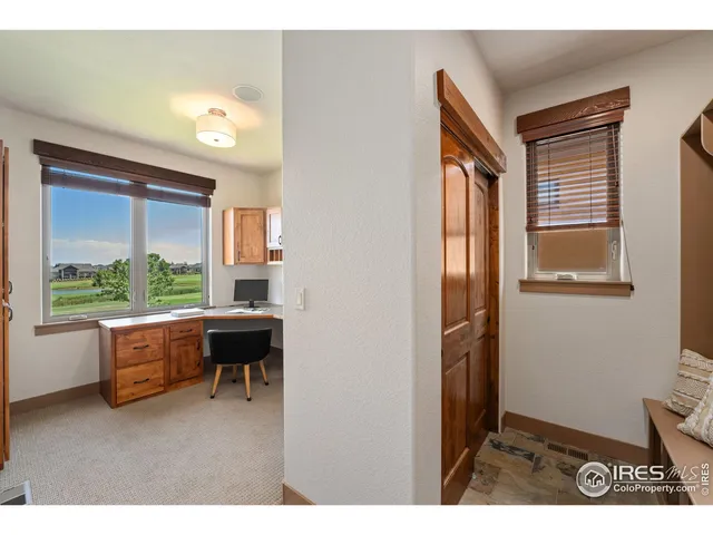 a dining room with furniture and a large window