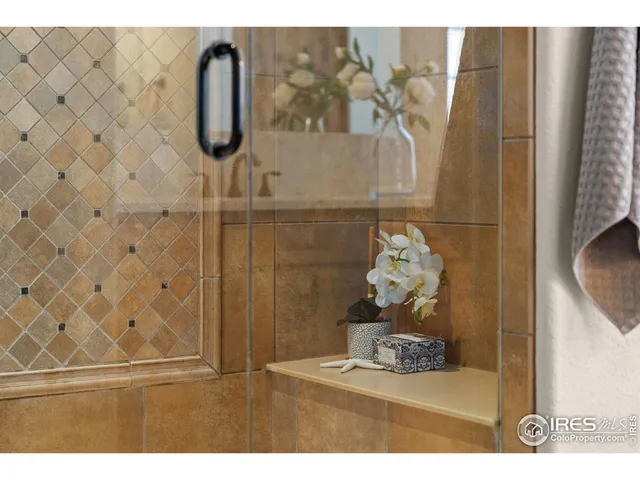 a view of an empty room with closet and wooden shelves