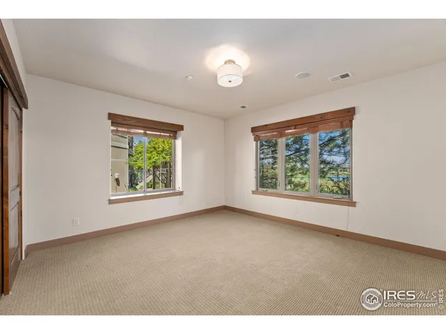 an empty room with windows and closet