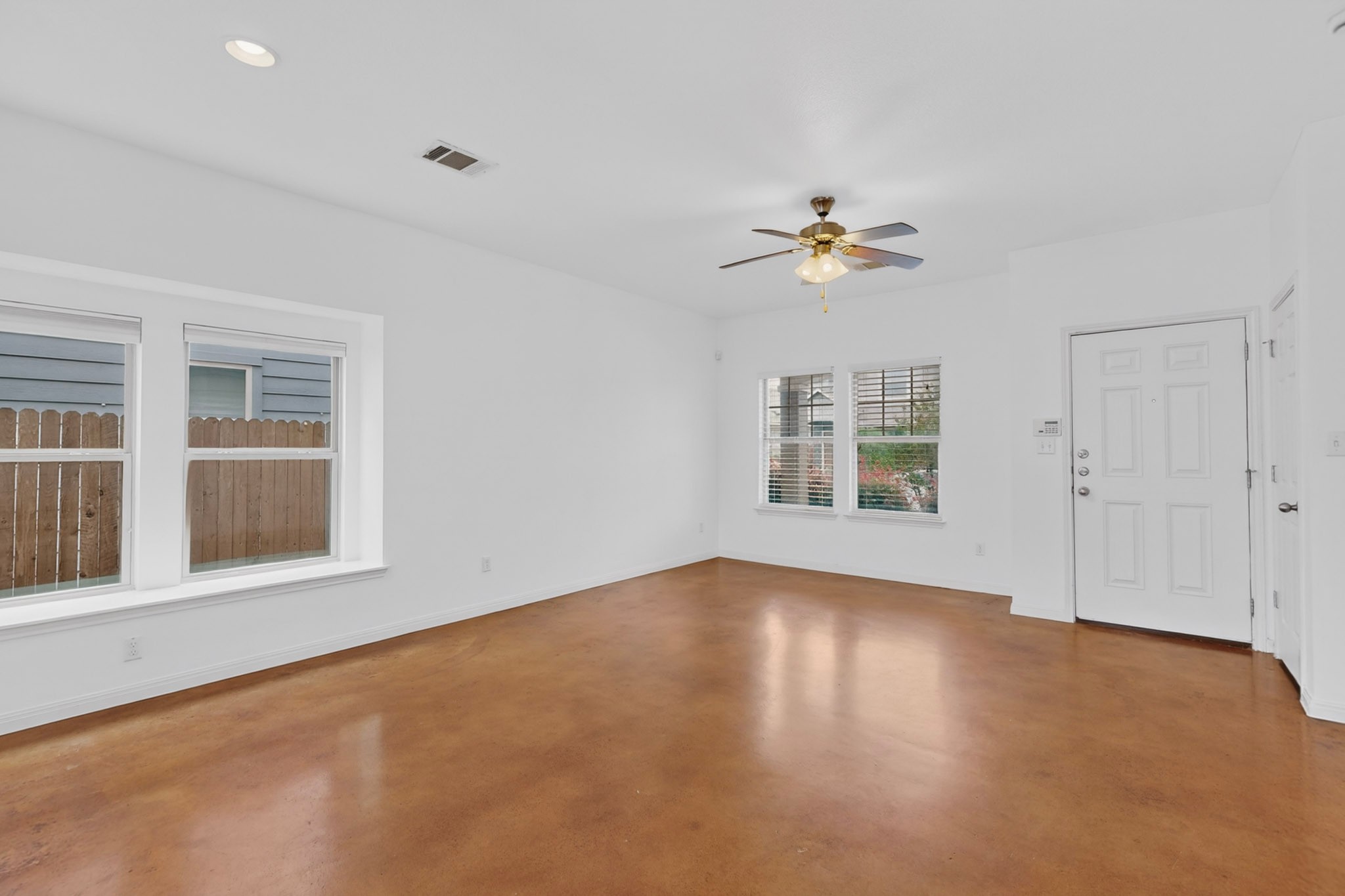 4619 Inicio Lane Austin, TX 78725 - Photo 5 of 32 a view of an empty room with a window and wooden floor