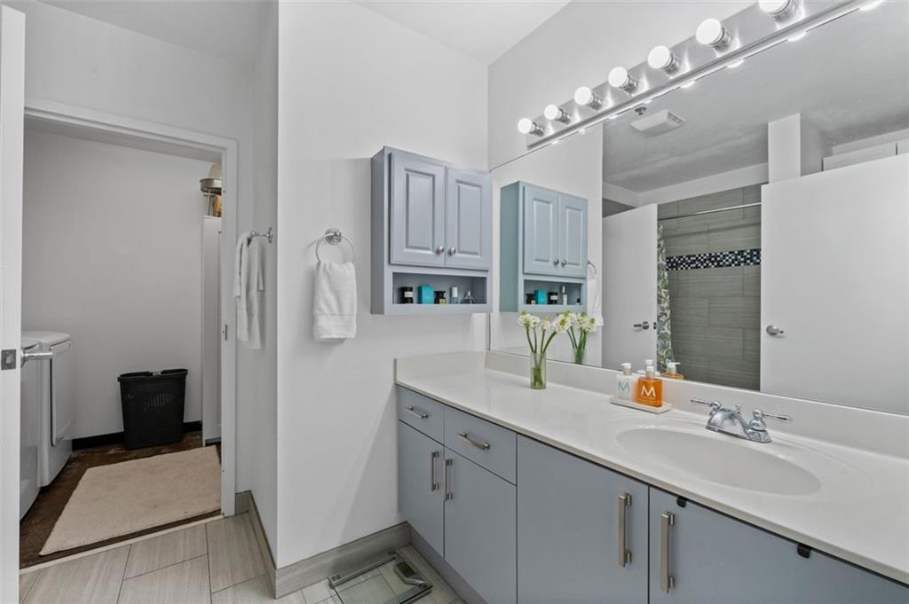 5200 Peachtree Road, Unit 2114 Chamblee, GA 30341 - Photo 11 of 26 a bathroom with a double vanity sink a mirror a vanity and a shower