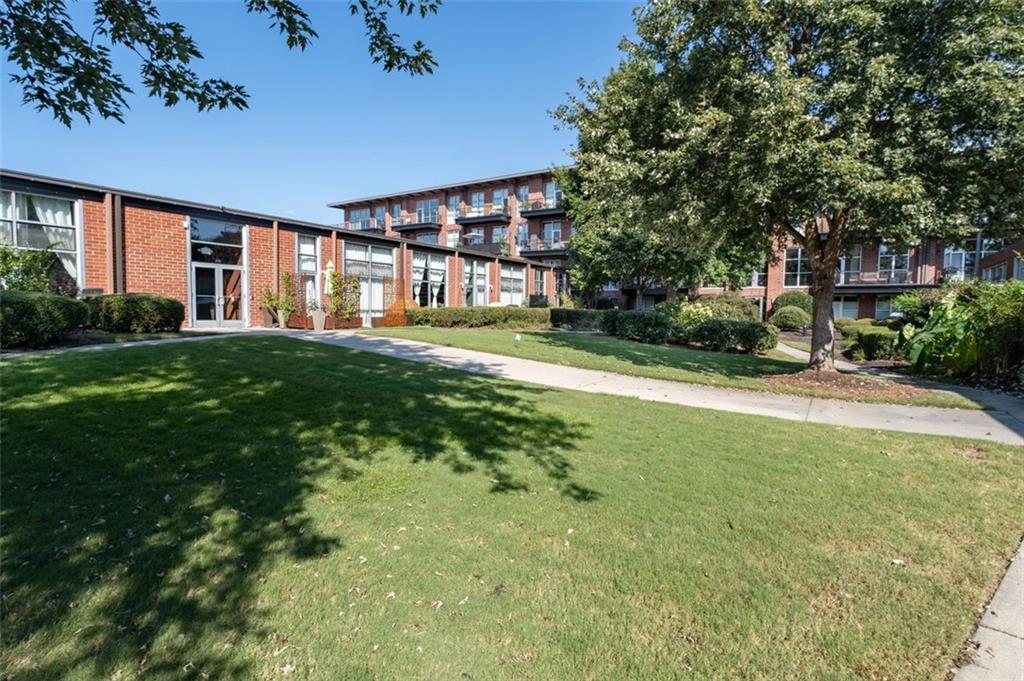 5200 Peachtree Road, Unit 2114 Chamblee, GA 30341 - Photo 14 of 26 a view of a house next to a big yard and large trees