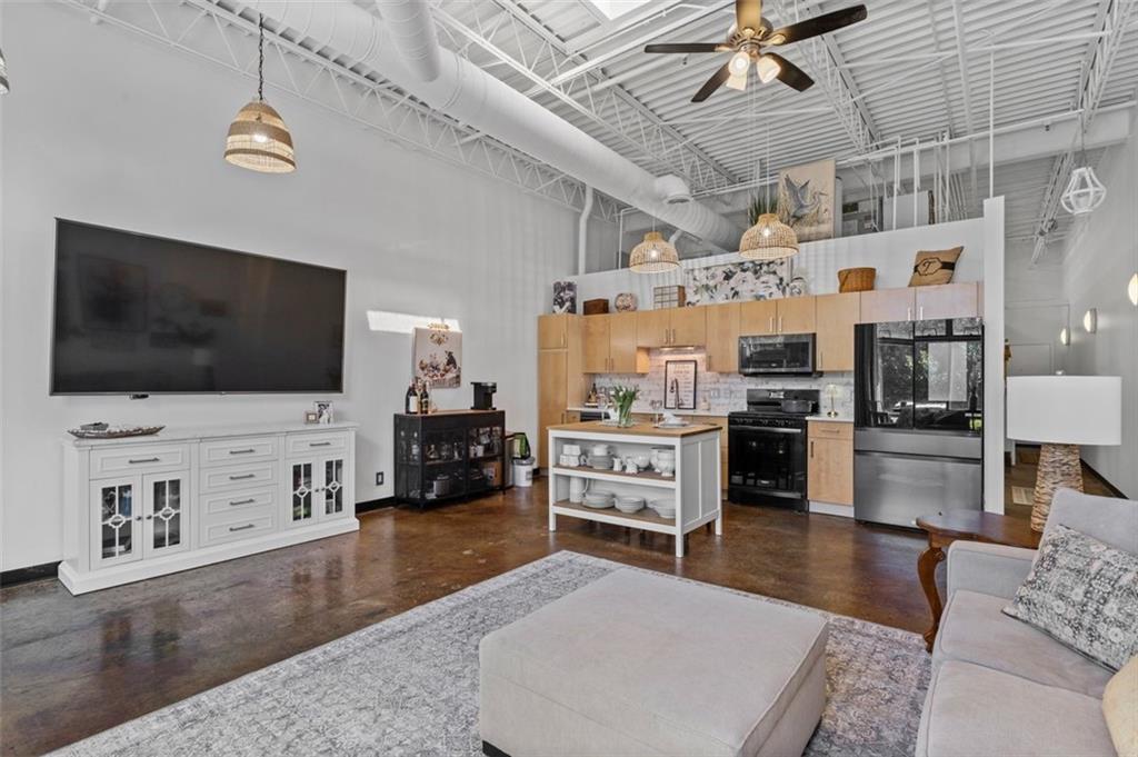 5200 Peachtree Road, Unit 2114 Chamblee, GA 30341 - Photo 16 of 26 a living room with furniture and a flat screen tv