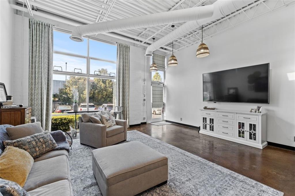 5200 Peachtree Road, Unit 2114 Chamblee, GA 30341 - Photo 20 of 26 a living room with furniture and a flat screen tv