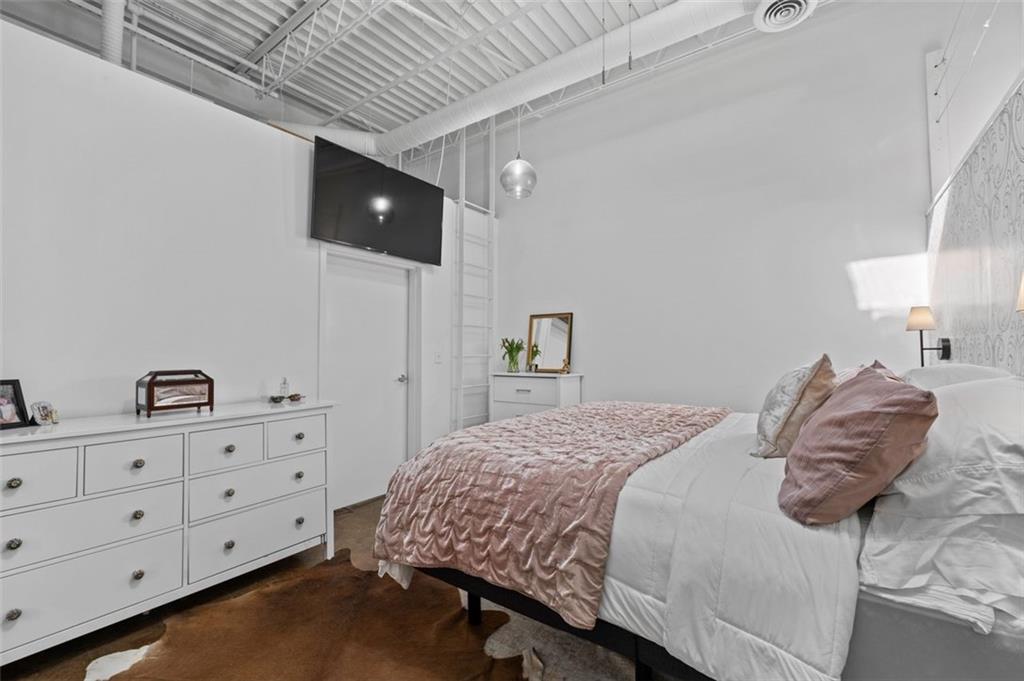 5200 Peachtree Road, Unit 2114 Chamblee, GA 30341 - Photo 21 of 26 a bedroom with a bed and a night stand