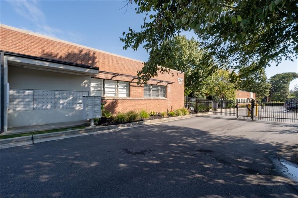 5200 Peachtree Road, Unit 2114 Chamblee, GA 30341 - Photo 22 of 26 a view of a house with a yard and garage