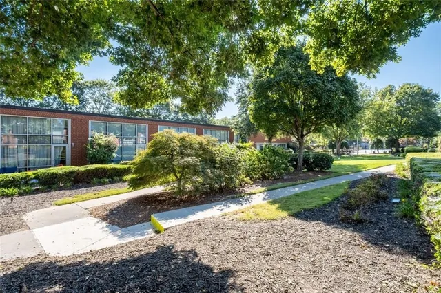 a view of a backyard with plants and swimming pool