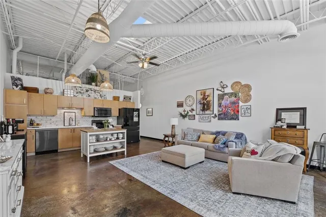 a living room with furniture and kitchen view