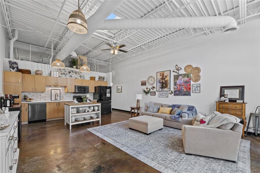 5200 Peachtree Road, Unit 2114 Chamblee, GA 30341 - Photo 4 of 26 a living room with furniture and kitchen view