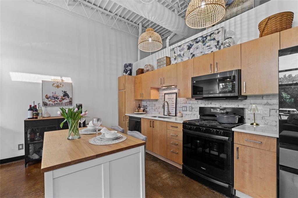 5200 Peachtree Road, Unit 2114 Chamblee, GA 30341 - Photo 7 of 26 a kitchen with stainless steel appliances a sink a stove and cabinets