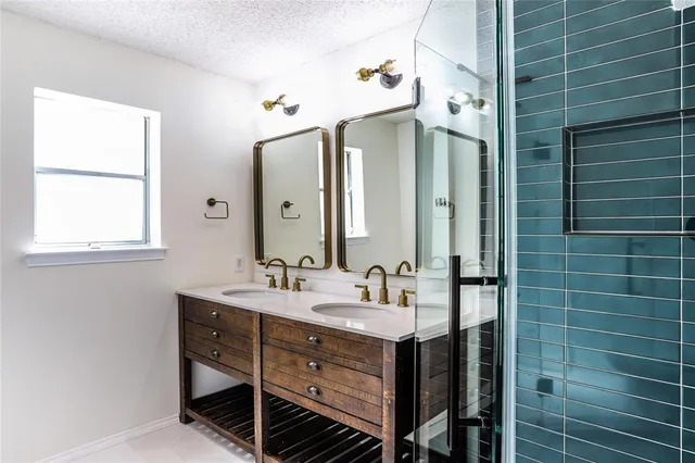 a bathroom with a double vanity sink mirror and double