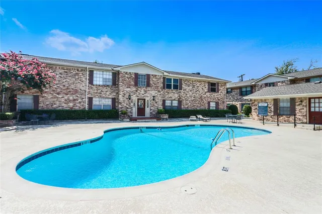 a view of house with swimming pool yard and outdoor seating