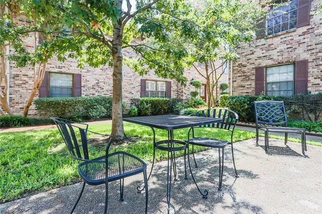 a view of a chairs and table in patio