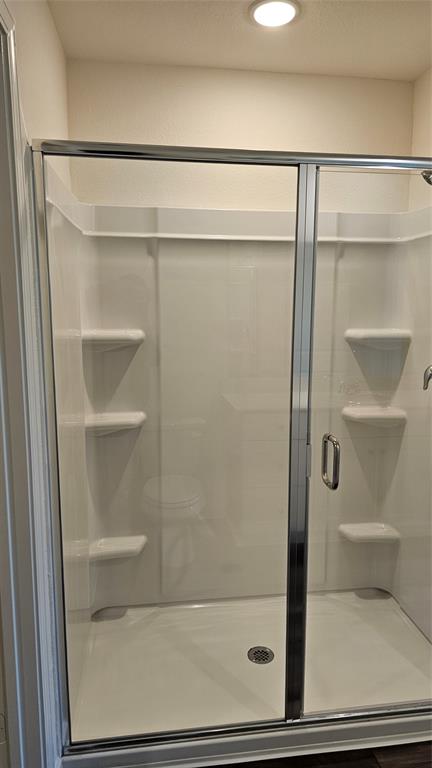 2102 Prairie Lane Melissa, TX 75454 - Photo 14 of 32 a bathroom with a glass shower door