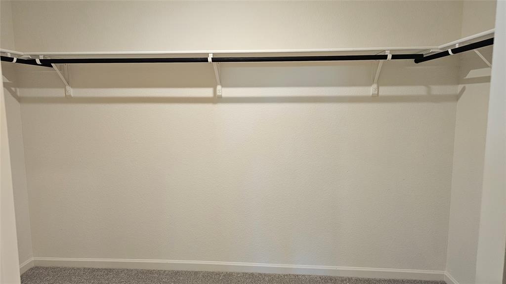 2102 Prairie Lane Melissa, TX 75454 - Photo 16 of 32 a view of walk in closet with racks on the wall