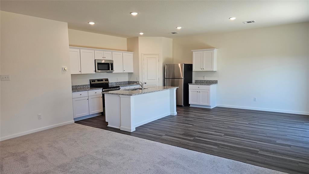 2102 Prairie Lane Melissa, TX 75454 - Photo 2 of 32 a kitchen with stainless steel appliances a refrigerator and a stove top oven