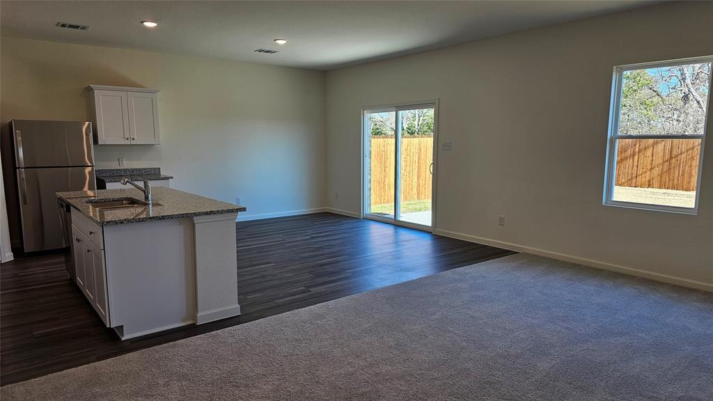 2102 Prairie Lane Melissa, TX 75454 - Photo 3 of 32 wooden floor in an empty room with a window