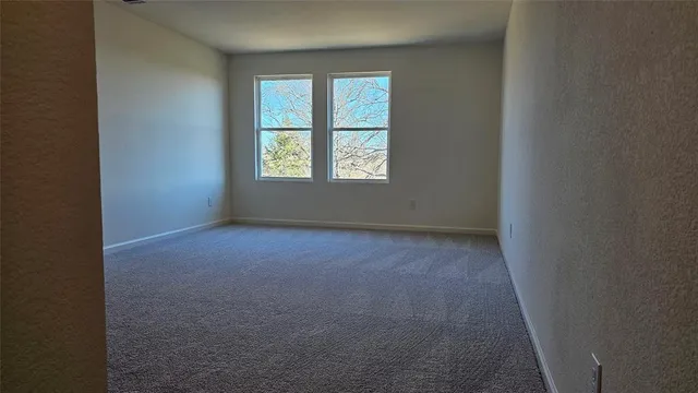 an empty room with windows and entryway