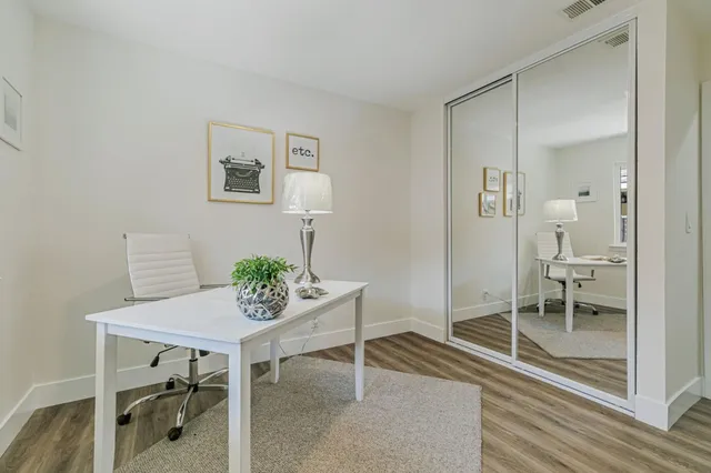 a view of a livingroom with furniture and a table in a room