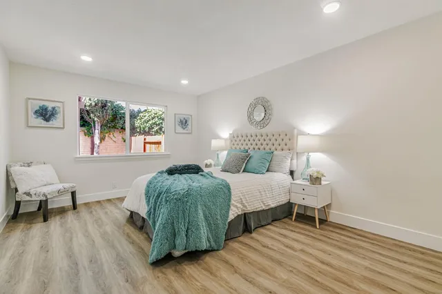 a bedroom with a bed and a large window