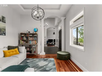 a living room with fireplace furniture and a chandelier