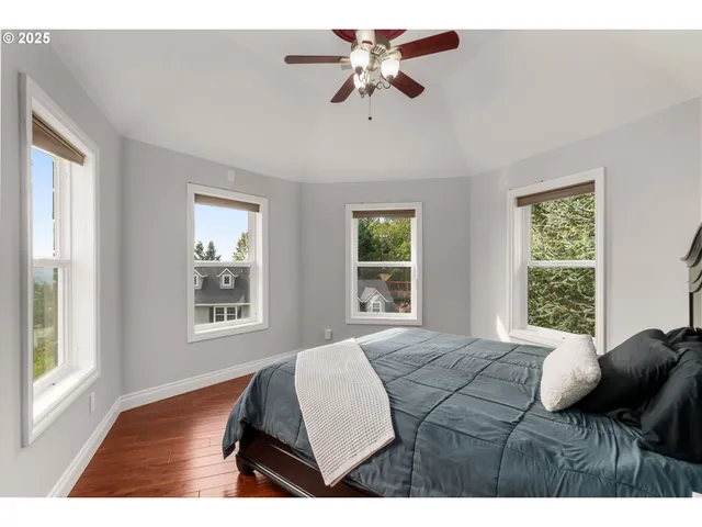 a bedroom with a bed window and a chandelier