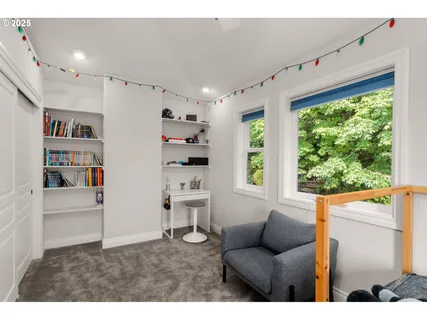 a living room with furniture and a book shelf