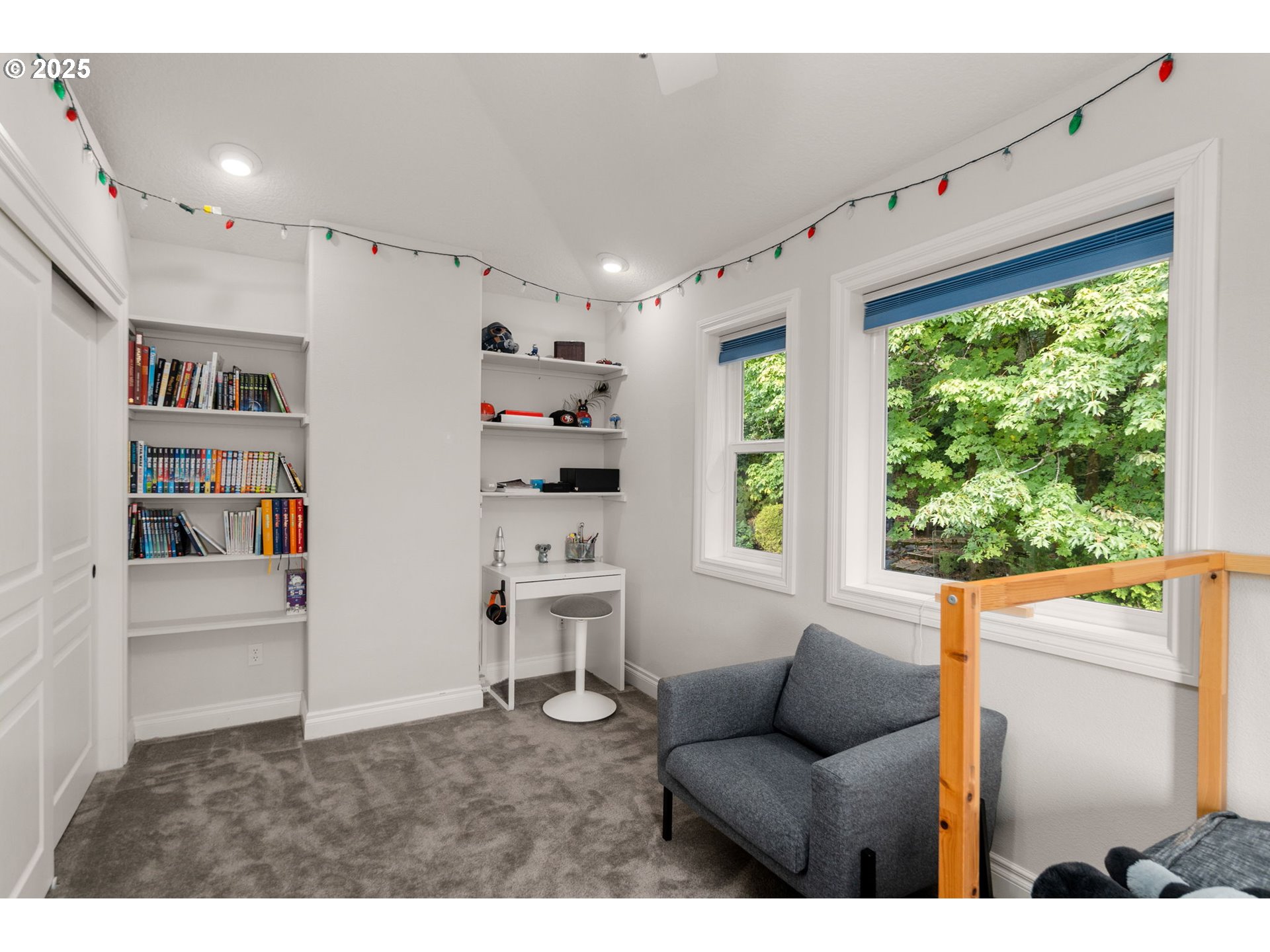 3720 Northwest Devoto Lane Portland, OR 97229 - Photo 21 of 44 a living room with furniture and a book shelf