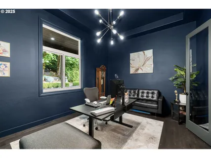a living room with furniture and potted plants
