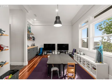 a living room with a table chairs and a flat screen tv