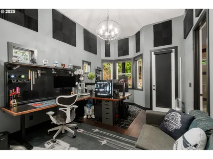 a living room with furniture a chandelier and a flat screen tv