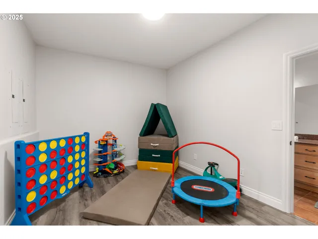 a living room with furniture and a baby crib