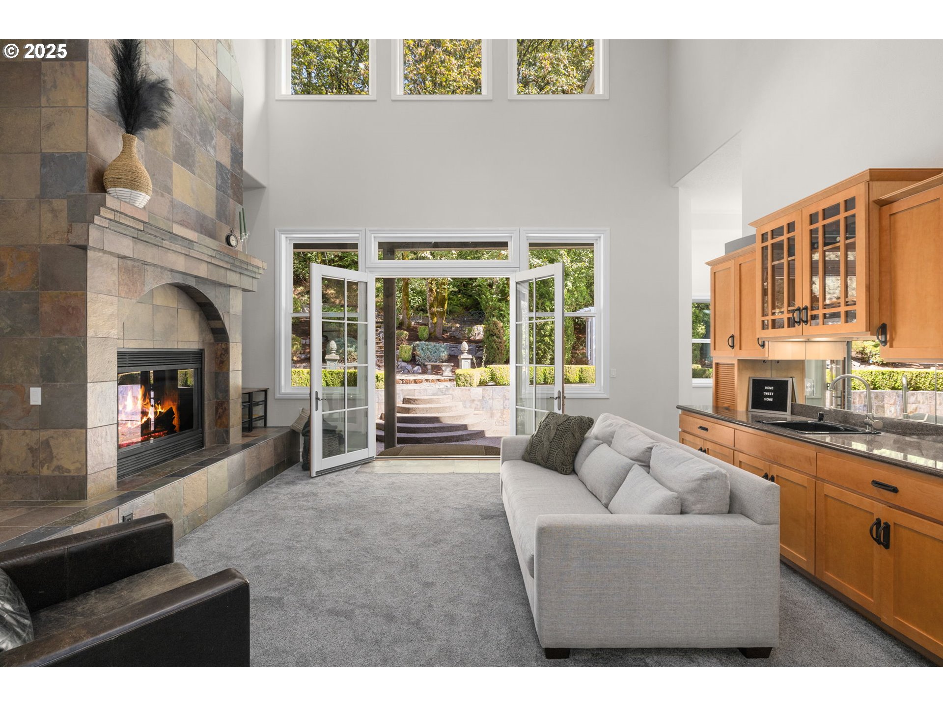 3720 Northwest Devoto Lane Portland, OR 97229 - Photo 3 of 44 a living room with furniture a fireplace and a flat screen tv