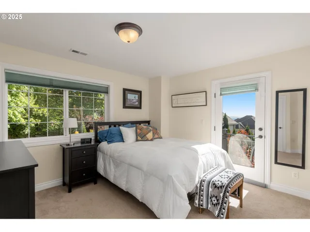 a bedroom with a bed and a large window