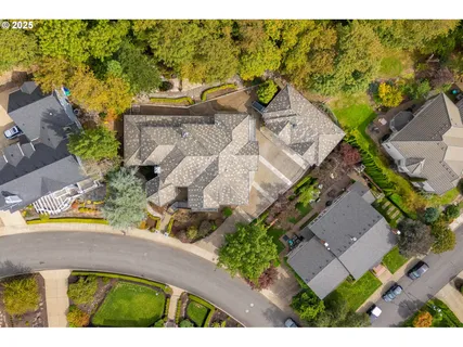 an aerial view of a house with a yard swimming pool and outdoor seating