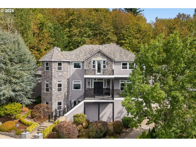 a front view of a house with a yard garage and outdoor seating