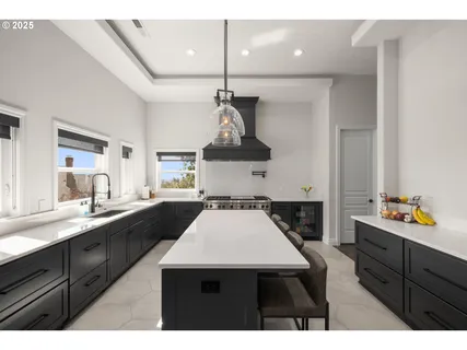 a kitchen with a sink a stove and cabinets