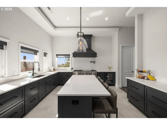 a kitchen with a sink a stove and cabinets