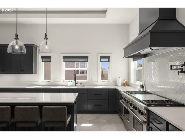 a kitchen with stainless steel appliances a sink stove and cabinets