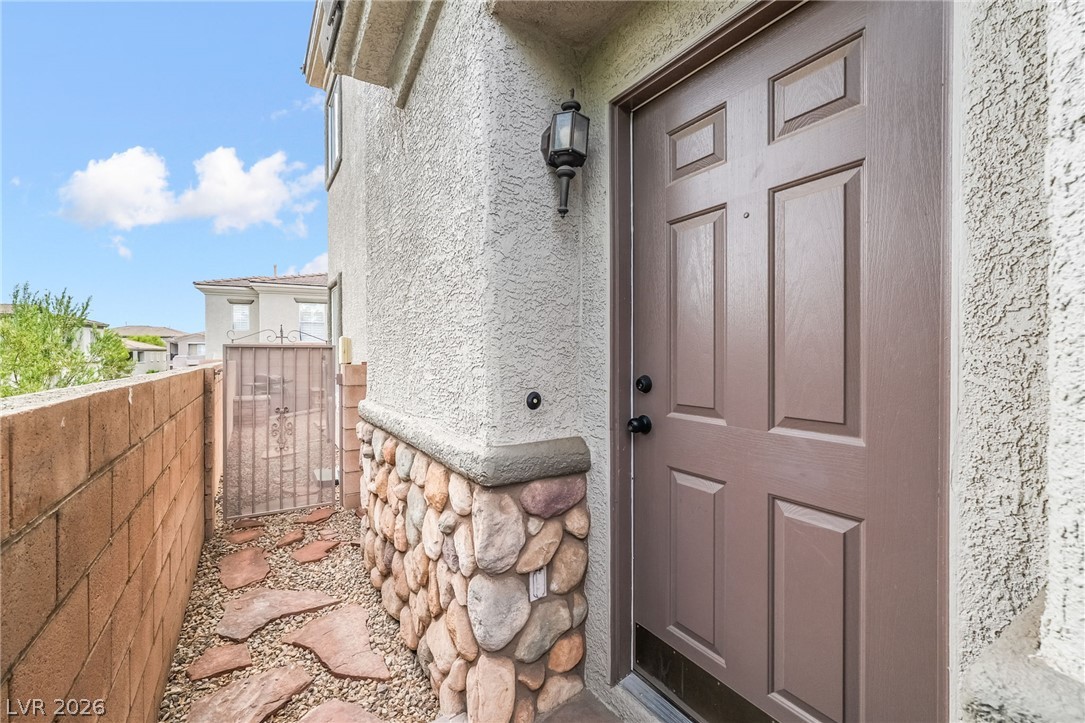 224 Positive Point Street Henderson, NV 89012 - Photo 4 of 44 Textured stucco and stone accents frame this welcoming private side entry.