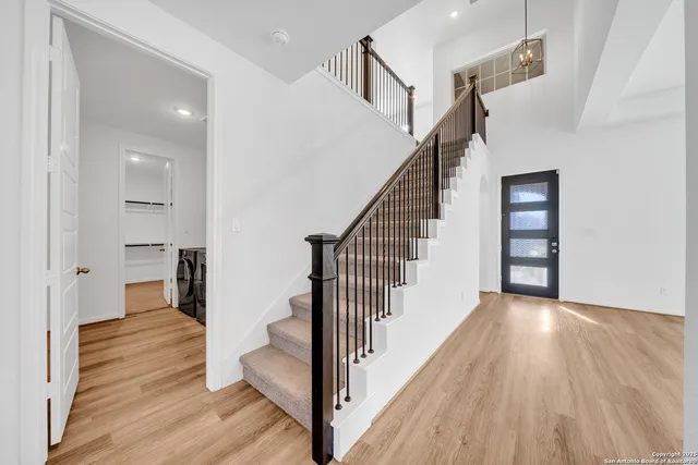 a view of a hallway view with wooden floor and staircase