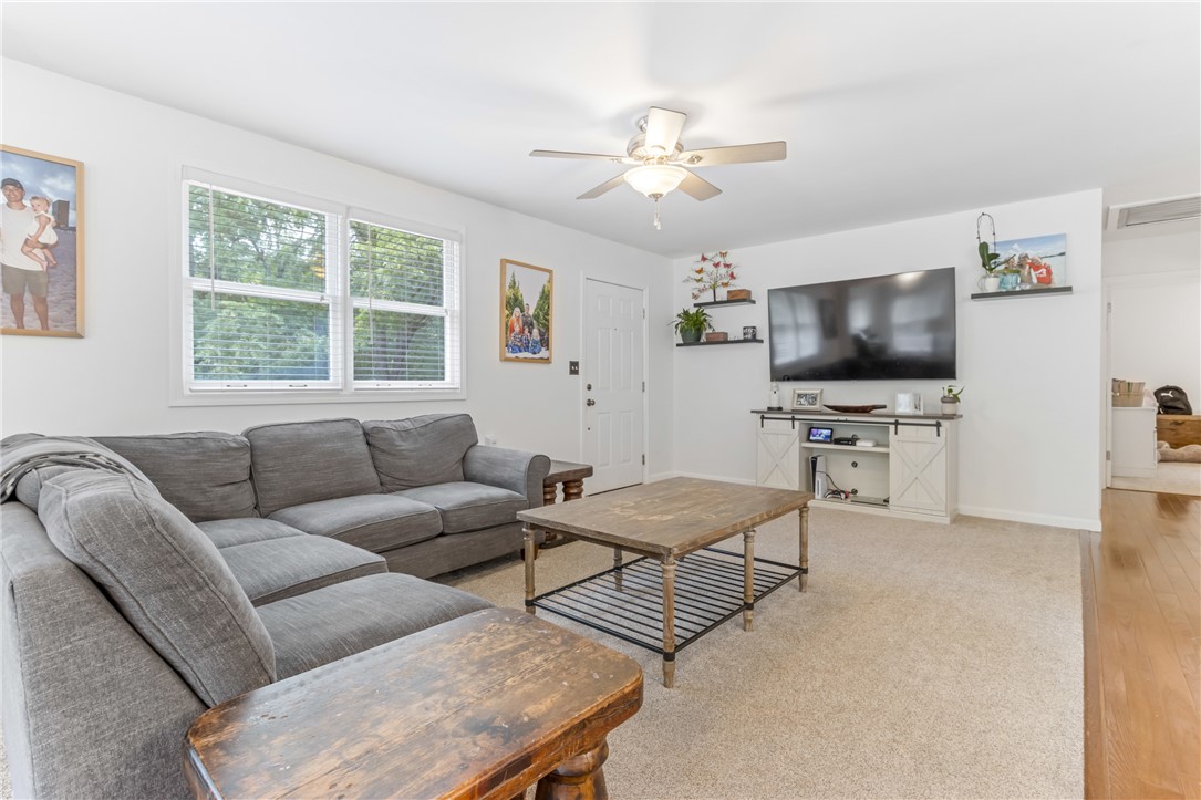 404 Davis Road Liberty, SC 29657 - Photo 13 of 39 Relax in this inviting living area featuring a ceiling fan, plush carpet, and large windows.
