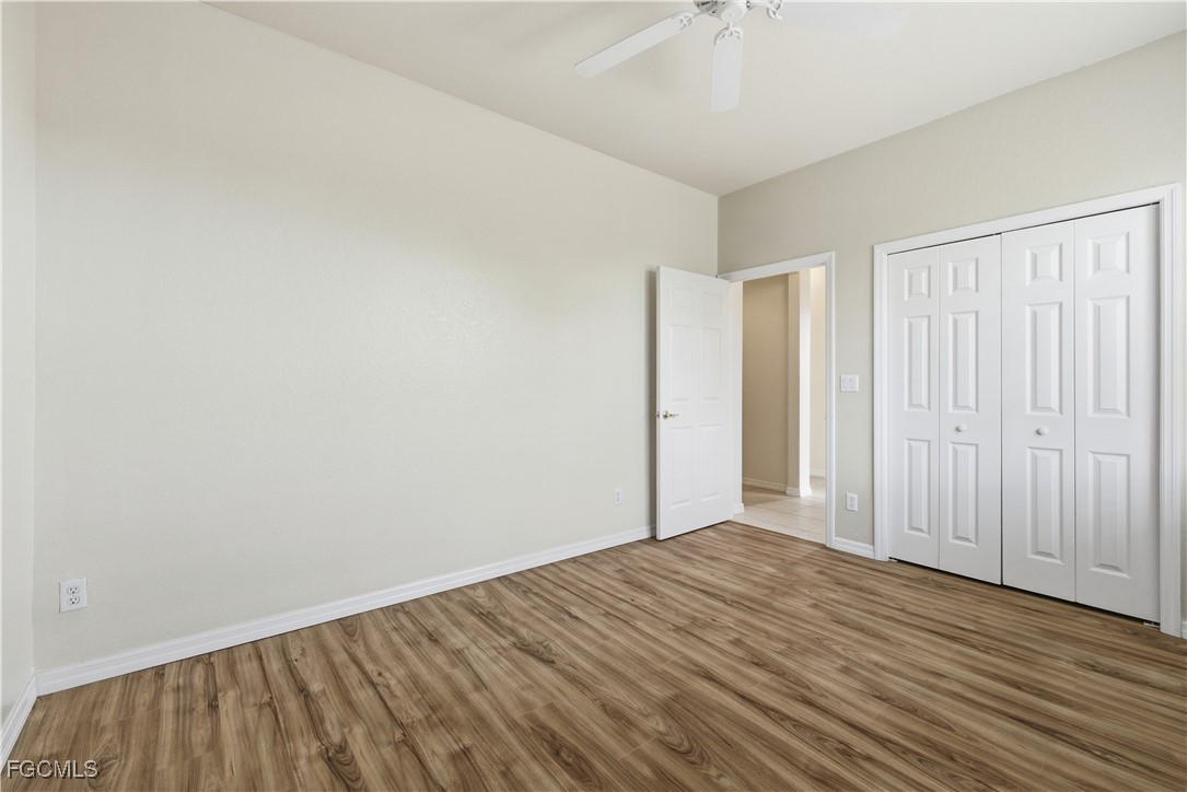 14951 Reflection Key Circle, Unit 536 Fort Myers, FL 33907 - Photo 18 of 36 a view of a room with wooden floor and fan
