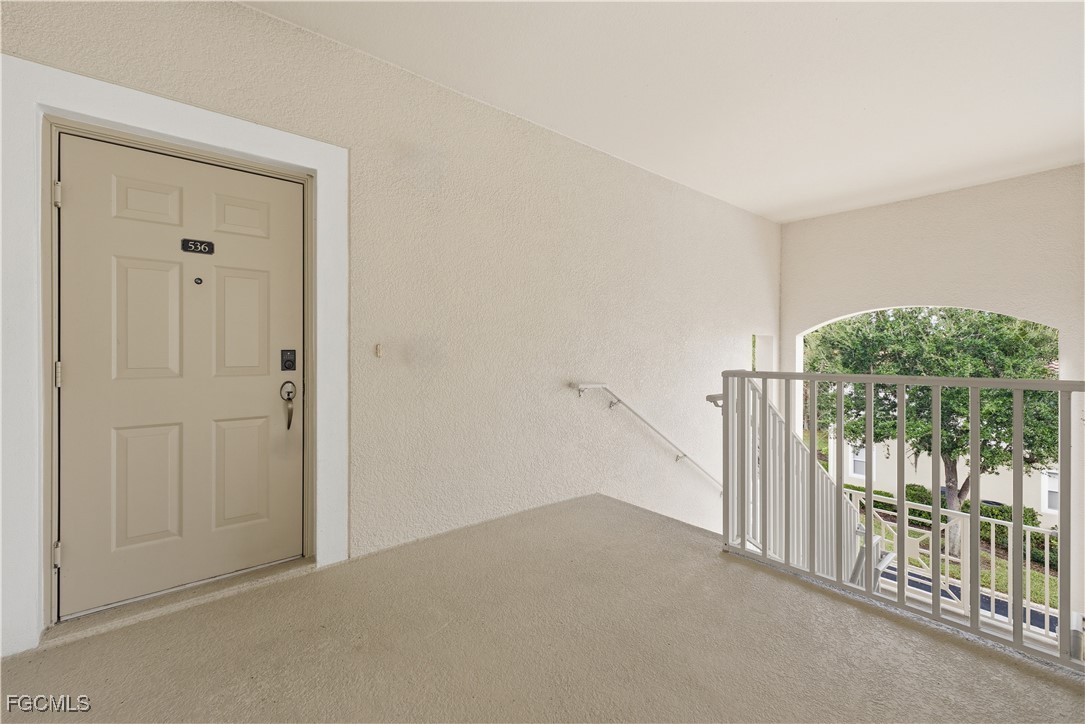 14951 Reflection Key Circle, Unit 536 Fort Myers, FL 33907 - Photo 2 of 36 a view of a hallway with sliding door and deck