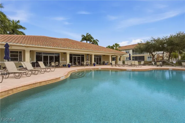a view of a house with pool porch and sitting area