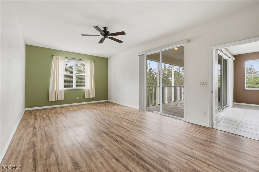 14951 Reflection Key Circle, Unit 536 Fort Myers, FL 33907 - Photo 10 of 36 a view of empty room with wooden floor and fan